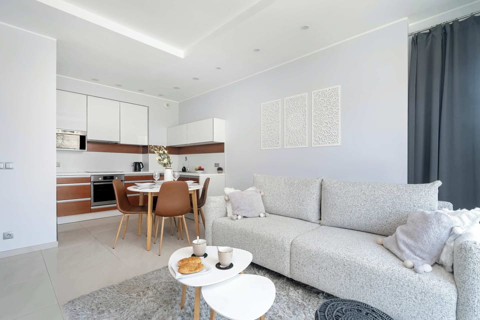 Kitchenette and dining area with bright living room.