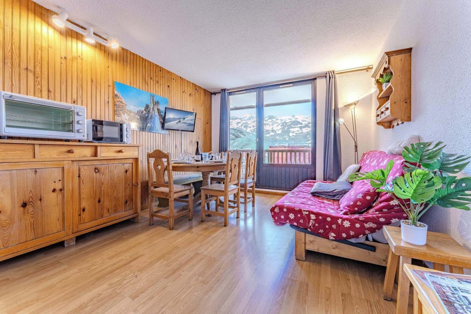 After a long ski day, sink into the comfort of this warm and welcoming sofa with snowy peaks as your