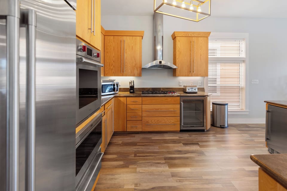 Your gourmet kitchen features premium appliances and warm wood cabinetry for memorable meal prep.