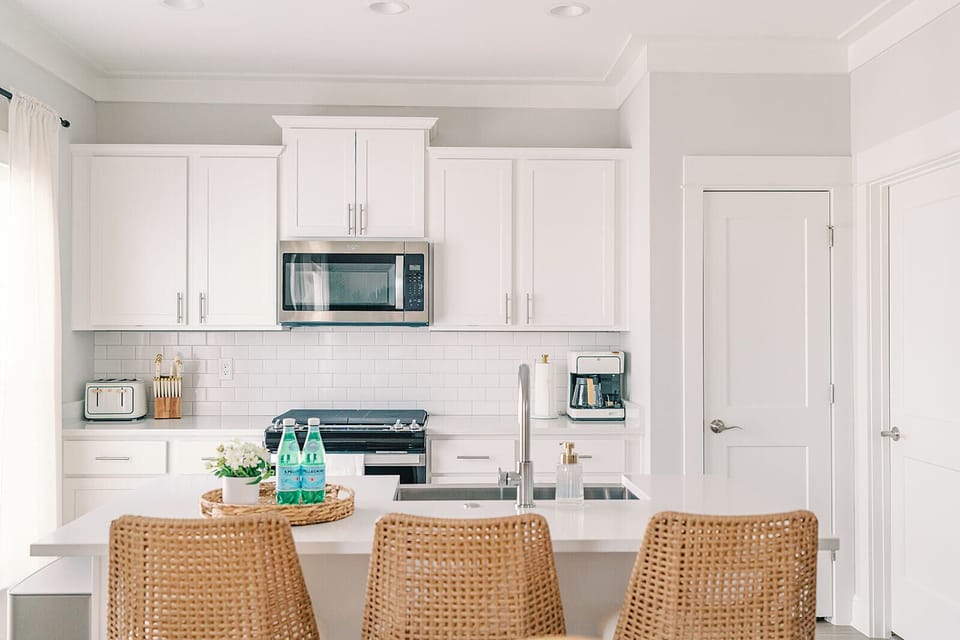 Cook, dine, and unwind in this bright kitchen featuring stainless steel appliances, a spacious island, and all the essentials for a seamless stay. Perfect for morning coffee or evening meals shared with friends and family.