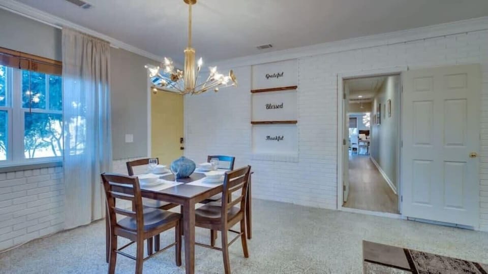 Dining space with a wooden table and colorful blue accents. A cheerful spot for sharing meals.
