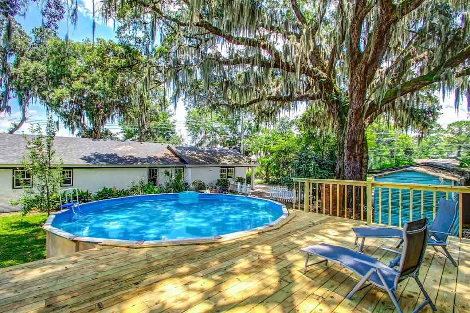 Welcome to your private oasis with a pool and a spacious wooden deck.