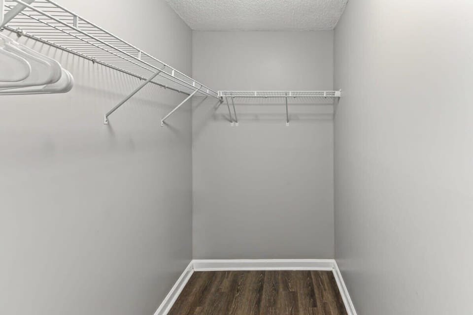 Walk-in closet with plenty of hanging space and shelving.