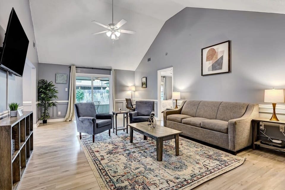 Bright living room with plush seating, vaulted ceilings, and plenty of natural light.