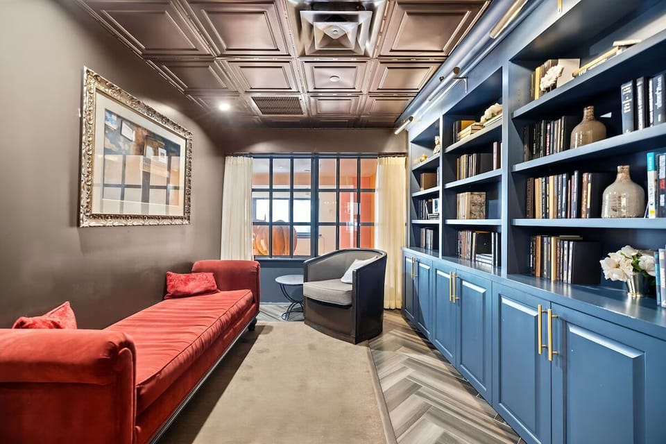 Settle in with a book beside built-ins and velvet seating.