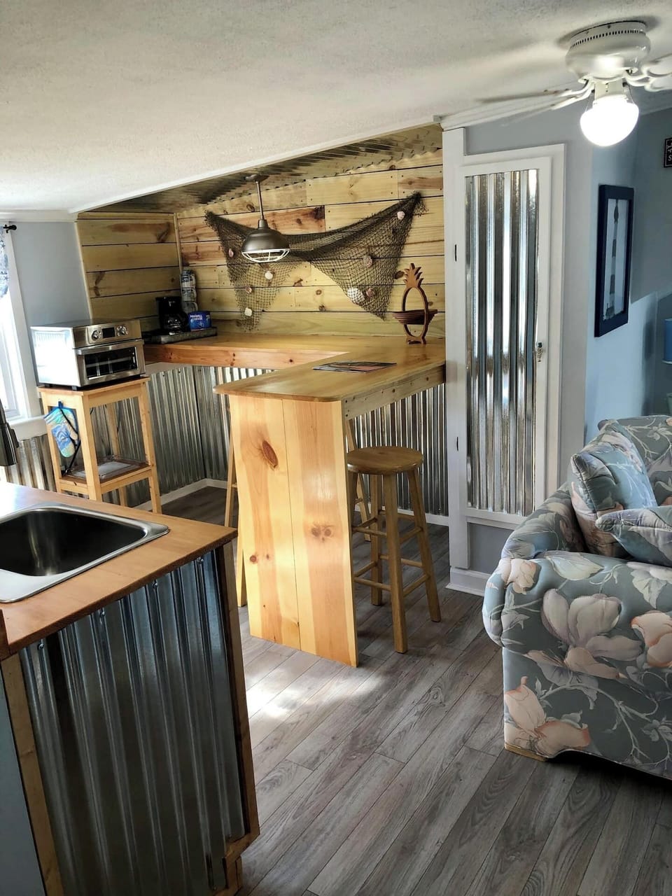 Kitchenette with Kuerig coffee maker, refrigerator, toaster oven and stovetop