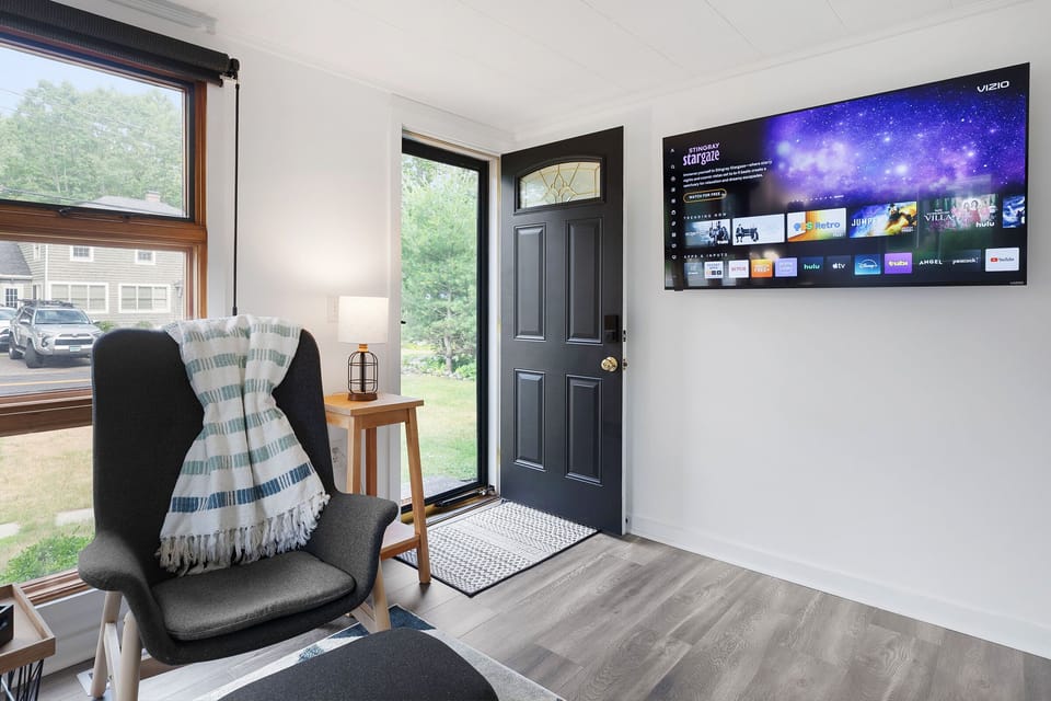 Step into an open-concept living room and kitchen with a smart TV.