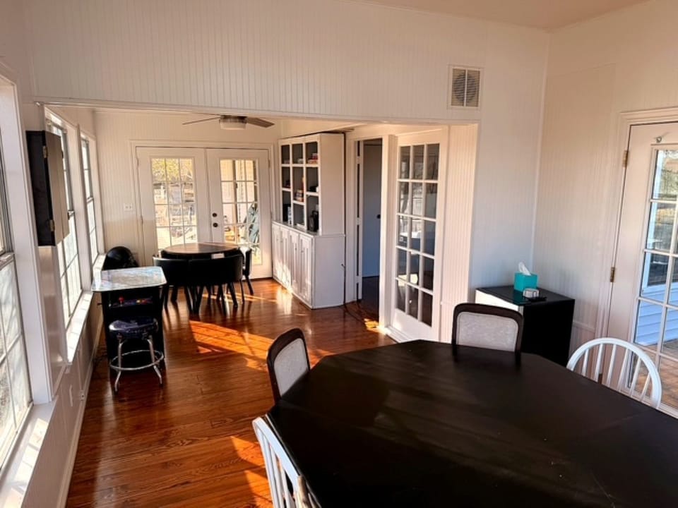 Game room with poker table, arcade game, and hang out space. 