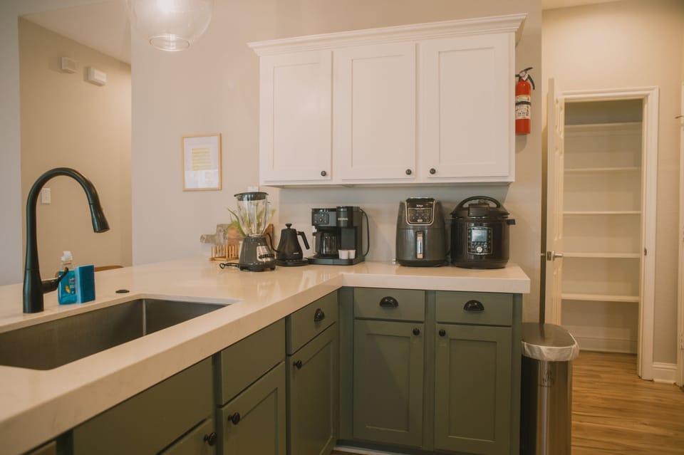 Everything you need for morning coffee or a quick bite! This well-appointed kitchen counter features essential appliances and ample space for your culinary needs.