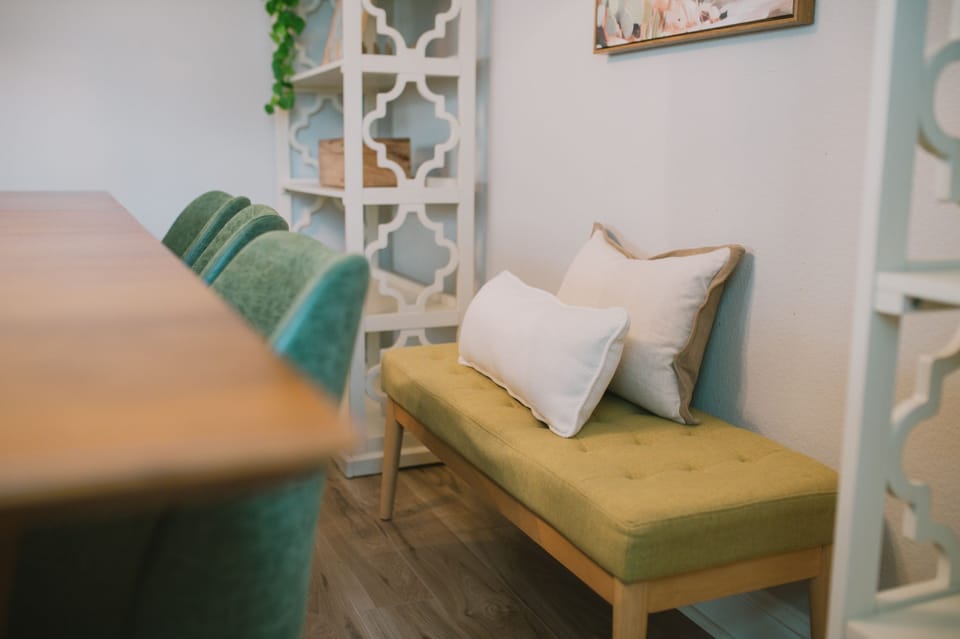 Enjoy the thoughtful details that make our dining area so inviting, from the comfortable bench seating to the charming decor on the nearby shelves.