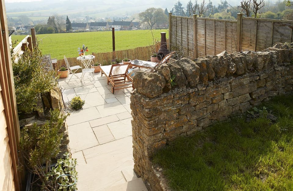 The sun terrace with sun loungers, chiminea and Weber charcoal barbecue