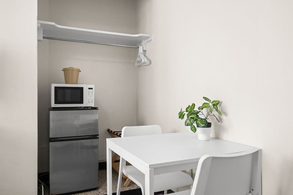 Beyond just a bed! This versatile space offers a comfortable sleeping area plus a cozy nook with a table and chairs, perfect for morning coffee or a quick bite.