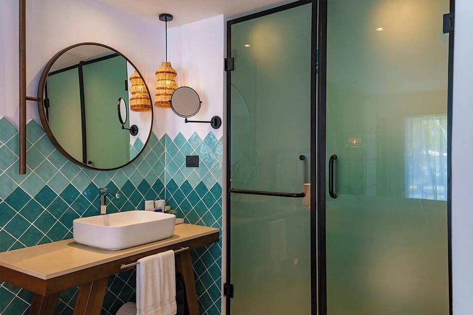 Enjoy a sleek vanity and frosted-glass shower for privacy.