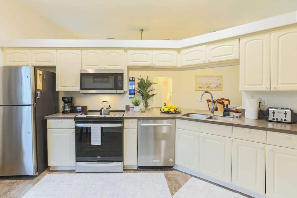 The kitchen opens up to the dining area, creating a perfect space to gather, laugh, and share meals after a day in the Florida sun.