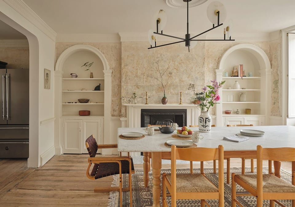 An elegant space for memorable meals, this room features a beautiful marble dining table set for ten. With tall sash windows overlooking Hawley Square, original timber floors, and an open fireplace, it's ideal for family dinners, celebratory feasts, 