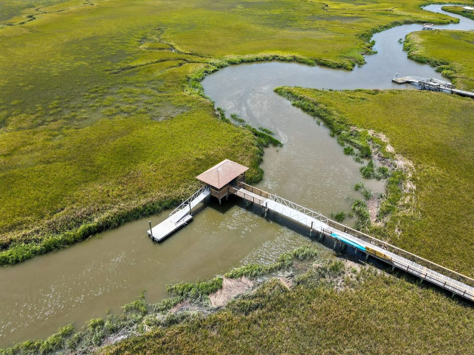 The Osprey Nest • Dock Over Meandering Coastal Tidal Creek - Set at a scenic bend in the coastal creek, The Osprey Nest’s private dock offers breathtaking views in every direction. Dock access requires a signed waiver and is ideal for peaceful observation and photo ops.