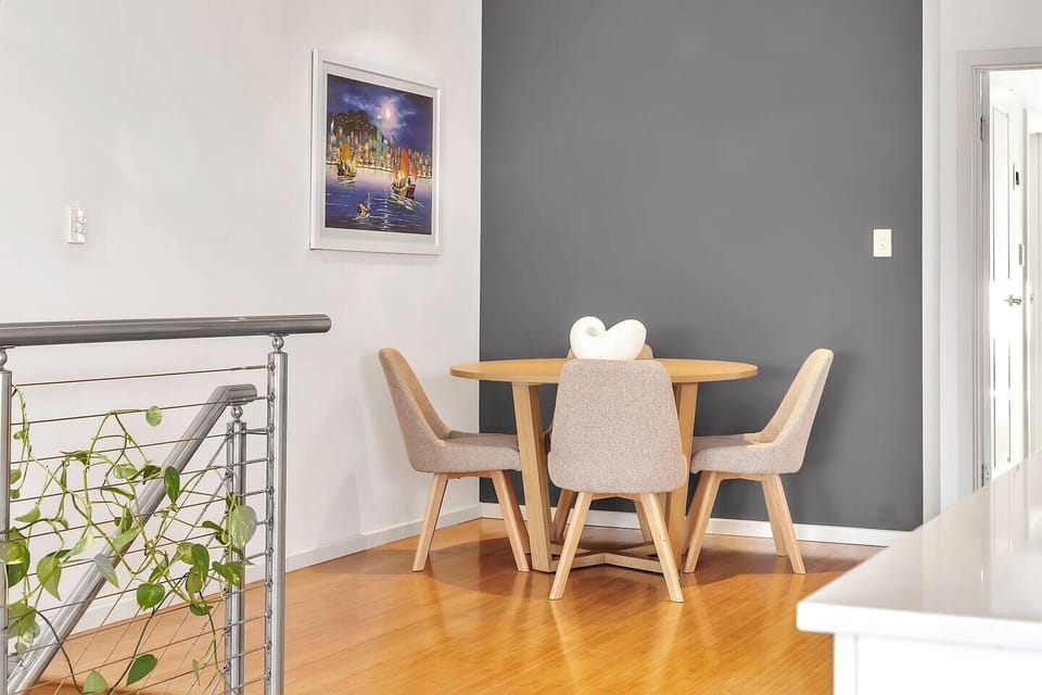 The cosy table for four is a quiet spot for reading, sipping wine, or planning your next beach day.