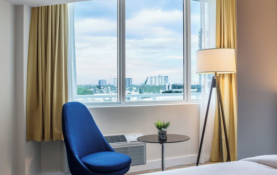 Unwind by the window with skyline views and cozy seating.