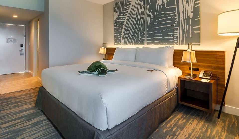 Recharge in warm ambient lighting with hotel-style bedside comforts.