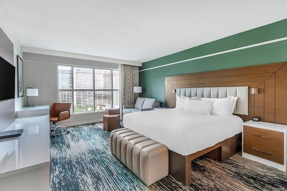 Unwind in a sunlit king room with city views.