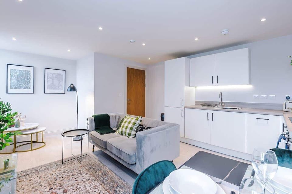 Bright living room with a comfy sofa, smart TV with Netflix, and large windows. Includes 2 fold-out chair beds that convert into single beds, offering extra sleeping space for up to 2 guests. Stylish wall art adds a modern touch.
