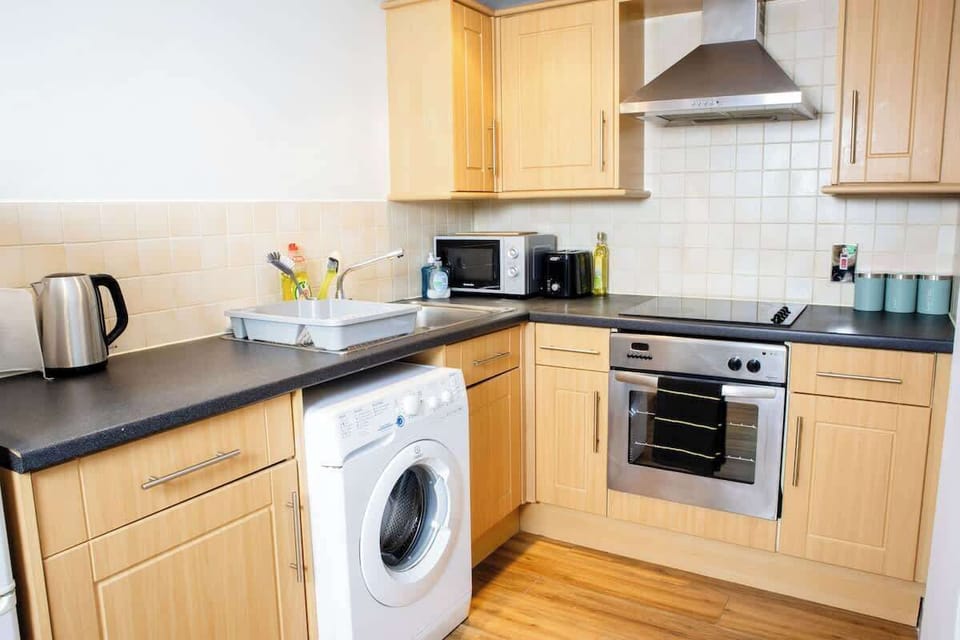 A full kitchen is equipped with all essential appliances and fixtures for cooking, preparing, and storing food.