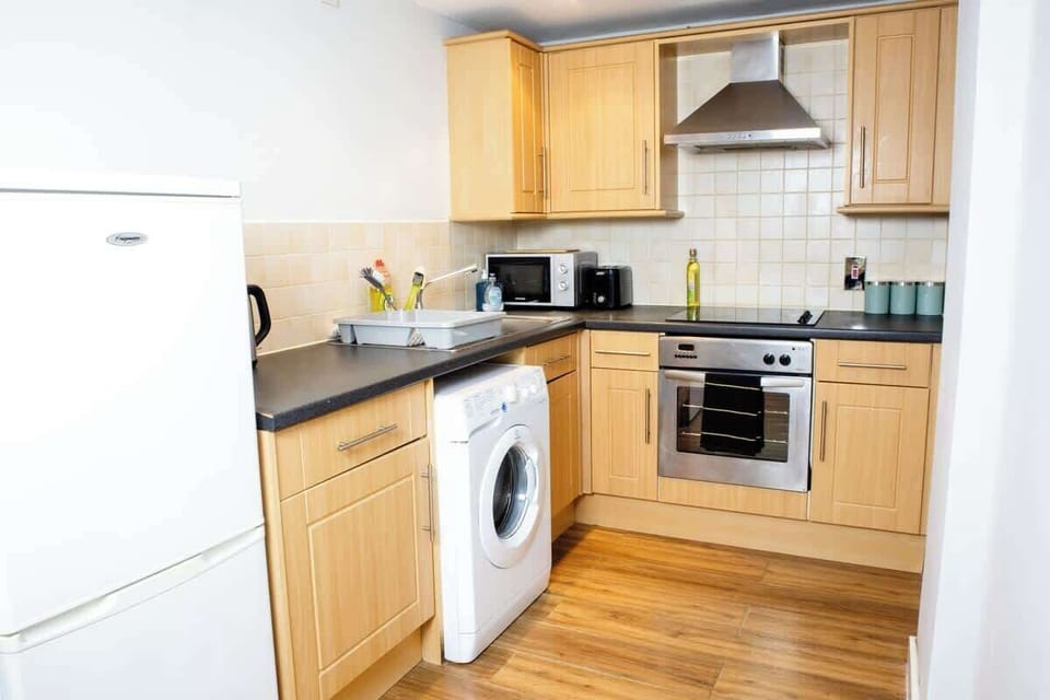 A full kitchen is equipped with all essential appliances and fixtures for cooking, preparing, and storing food.
