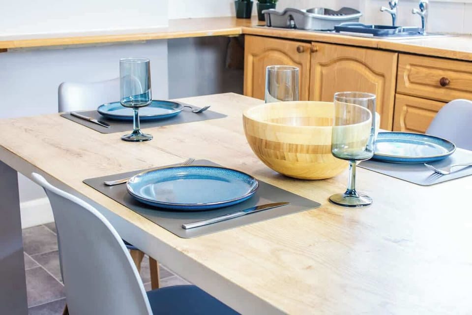 An elegant dining area with a stylish table, comfortable chairs, and ambient lighting, perfect for meals and gatherings.