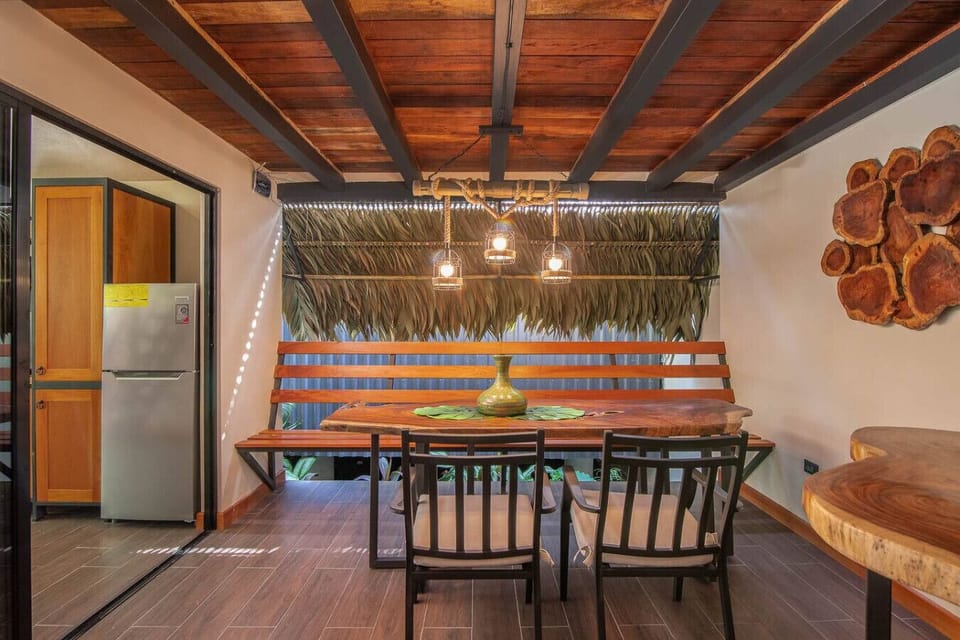 Terrace dining area with wooden table and warm lighting, Aloki Tsalú 1 in Playa Chiquita