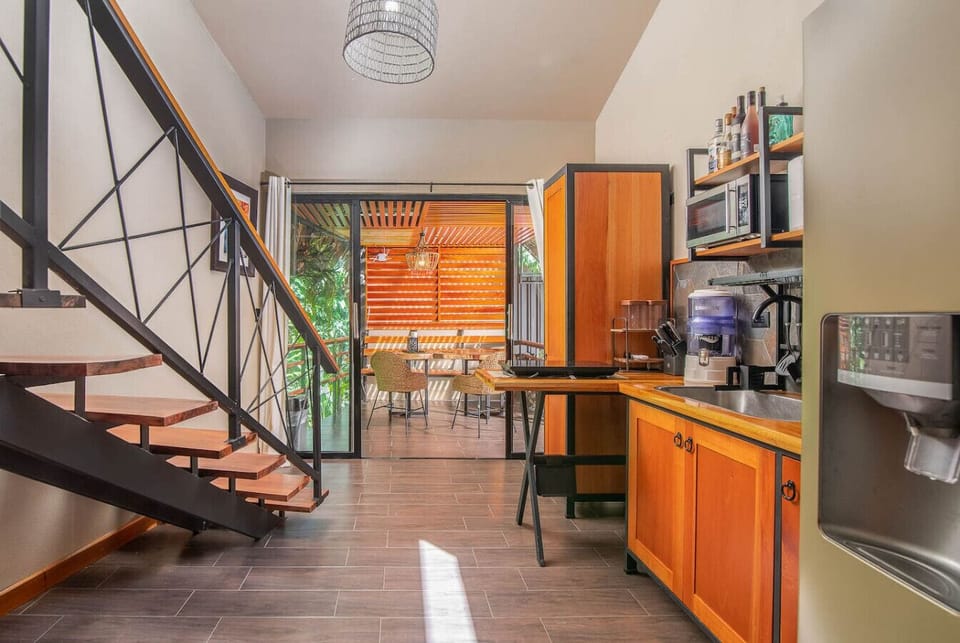 Equipped Kitchen - Aloki Wim 4Fully equipped kitchen with warm wood cabinetry, modern appliances, and open access to a covered terrace, Aloki Wim 4 in Playa Chiquita