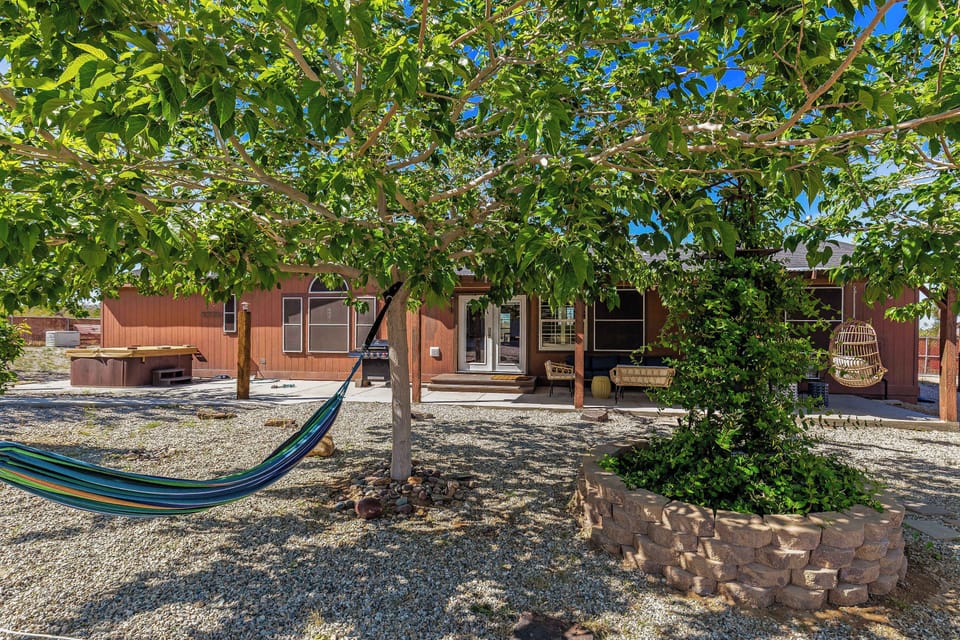 Desert vibes done right. Hot tub, hammock, and hangout-ready patio under the trees.