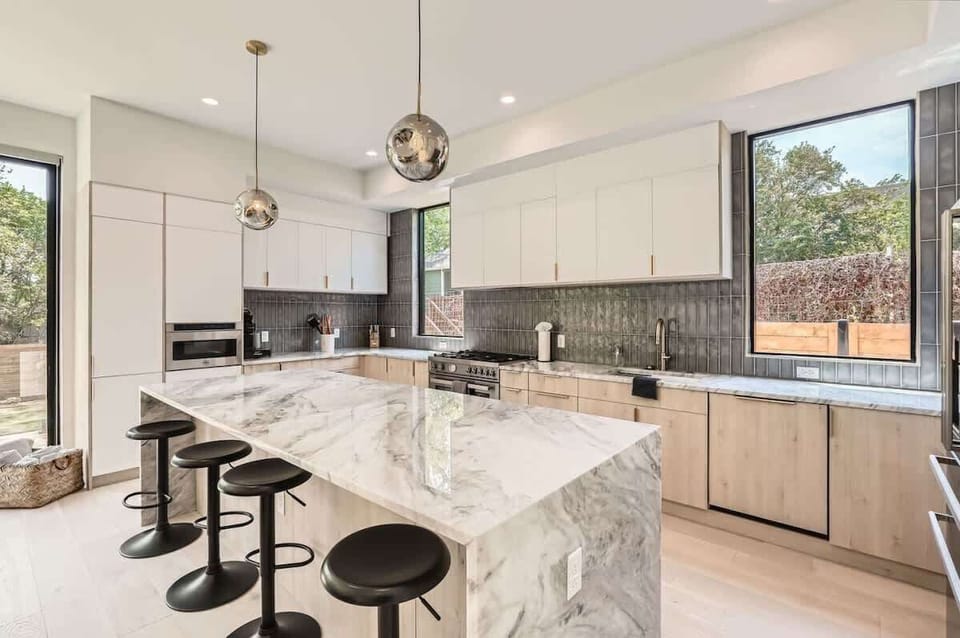 2. Spacious kitchen with a large island and seating, ideal for enjoying morning coffee or group meal prep.
