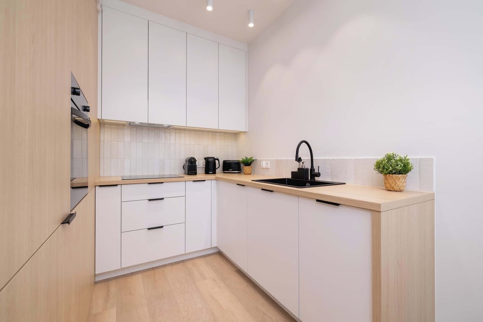 A bright, fully equipped kitchen with sleek cabinets lets you prepare any meal with ease.

