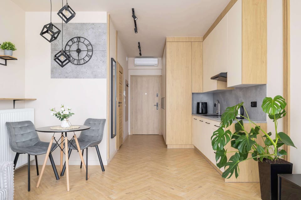 Fully equipped kitchenette and dining area with table and chairs.