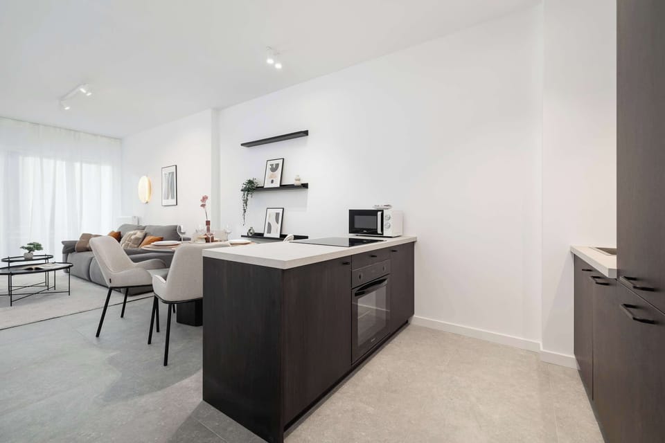 The sleek design of the kitchenette blending seamlessly with the living area.