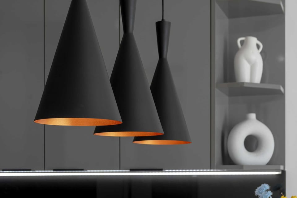 Designer pendant lights above the kitchen island catch the eye and add a touch of elegance.