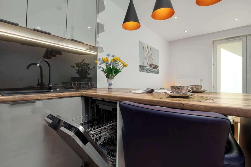 The kitchen island with comfortable seating and a built-in dishwasher blends functionality with elegant design.