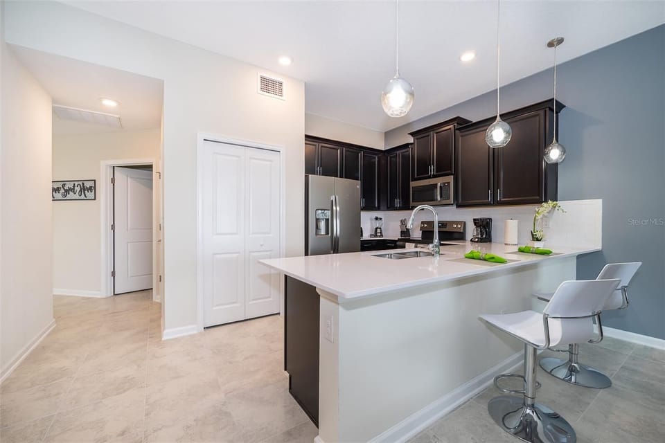 Bright and modern kitchen with ample counter space — designed for home-style cooking in Champions Gate