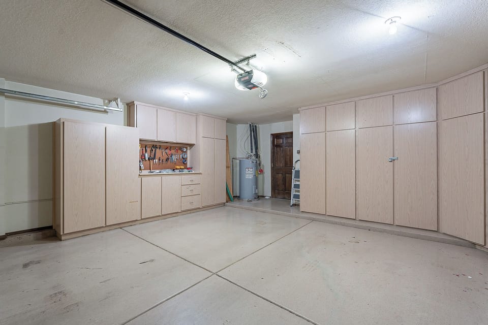 Garage with workbench and storage cabinets