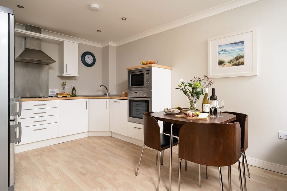 Dining room and kitchen at 11 Waves, Watergate Bay, Cornwall, self catering with Beach Retreats.