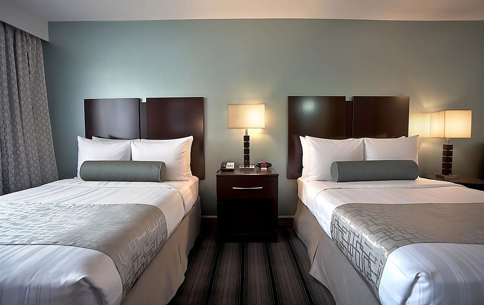 Drift off peacefully in crisp linens with soft lampside light.