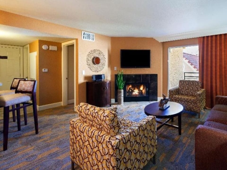 Unwind by the glowing fireplace in a spacious lounge.