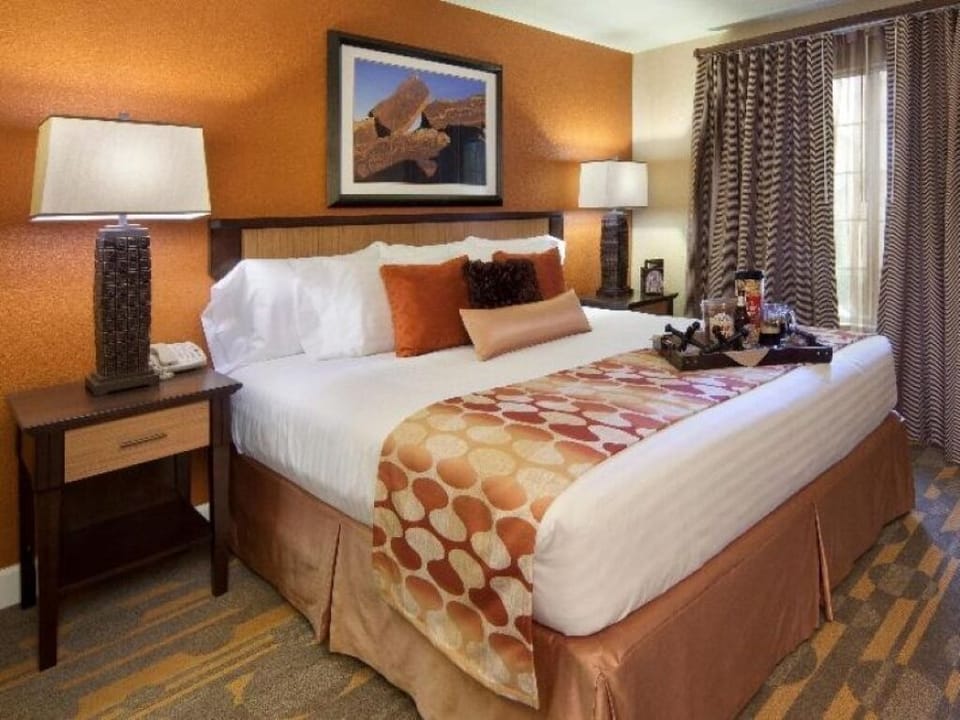 Drift off comfortably in a warm, welcoming bedroom setting.