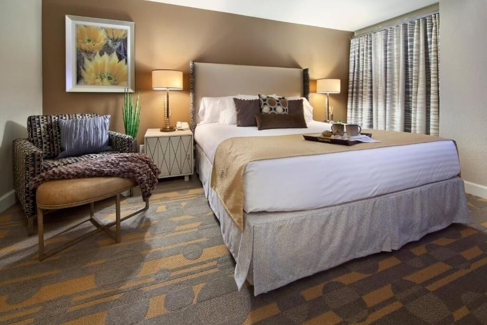 Unwind in a plush bed with warm, restful lighting.