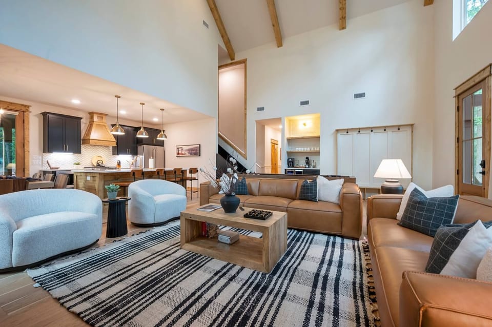 Open-concept living with seamless flow from the cozy lounge to the fully stocked kitchen and charming coffee bar—designed for comfort, connection, and convenience