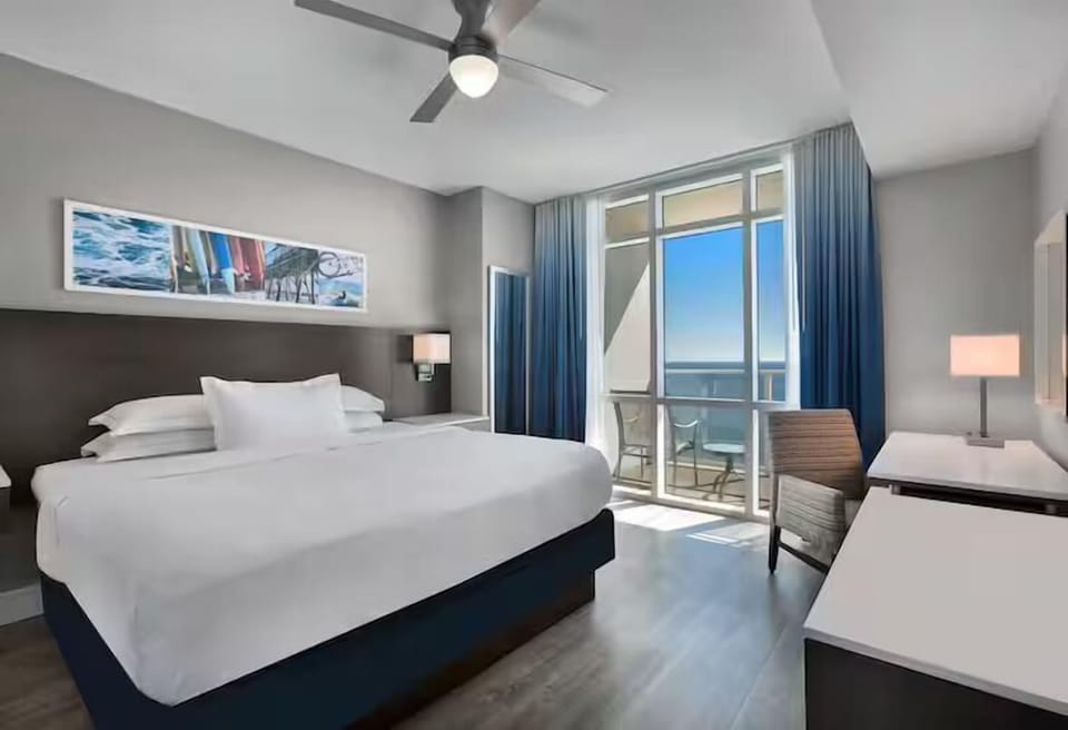Relax in a sunlit king room with breezy coastal views.