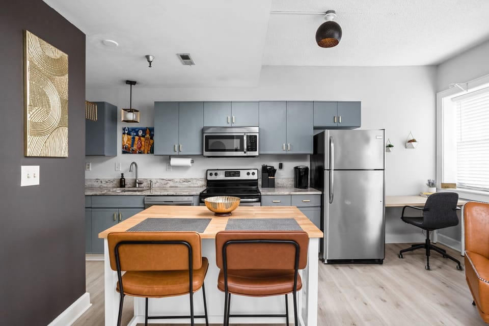 Modern meets inviting in this thoughtfully designed kitchen — complete with sleek stainless steel appliances, warm wood accents, and a stylish island perfect for dining or sipping your morning coffee. 