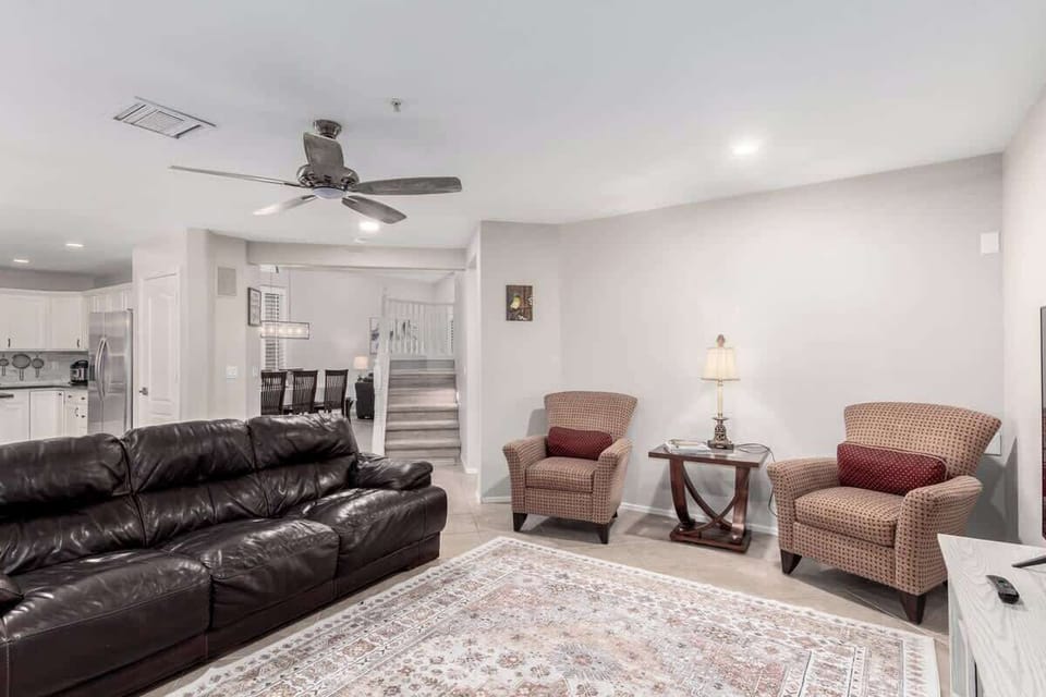 Living room with Smart TV, guitar, and keyboard for entertainment