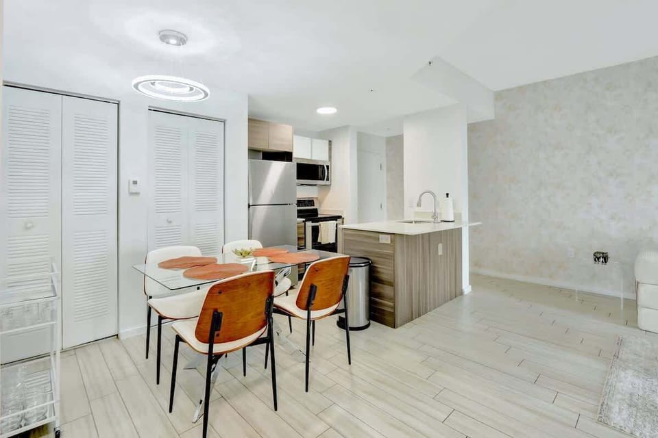 Intimate dining space with seating for four, great for meals, takeout, or catching up with friends.