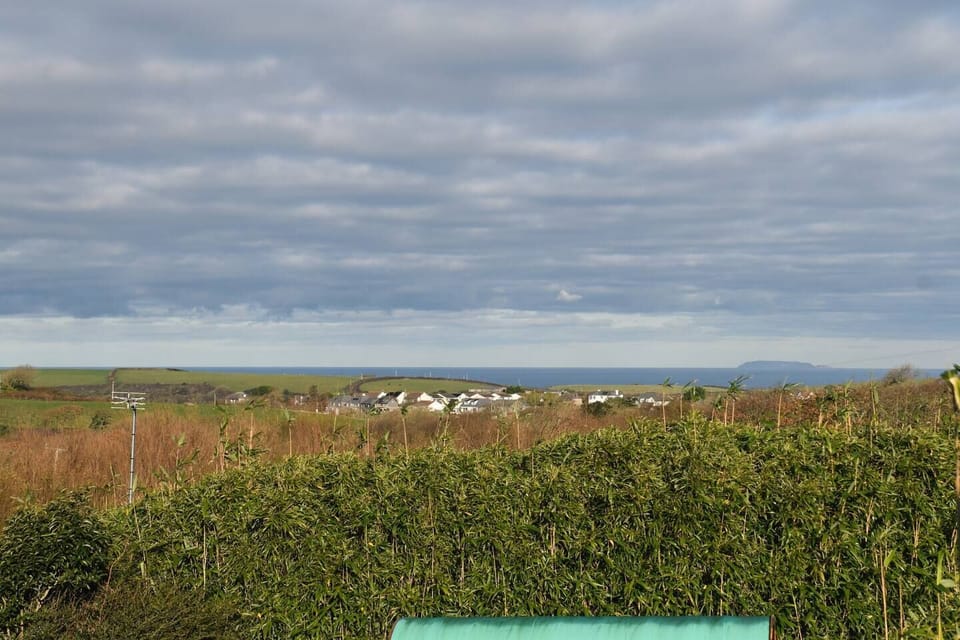 upstair view across the countryside to the coast and Lundy on a clear day.